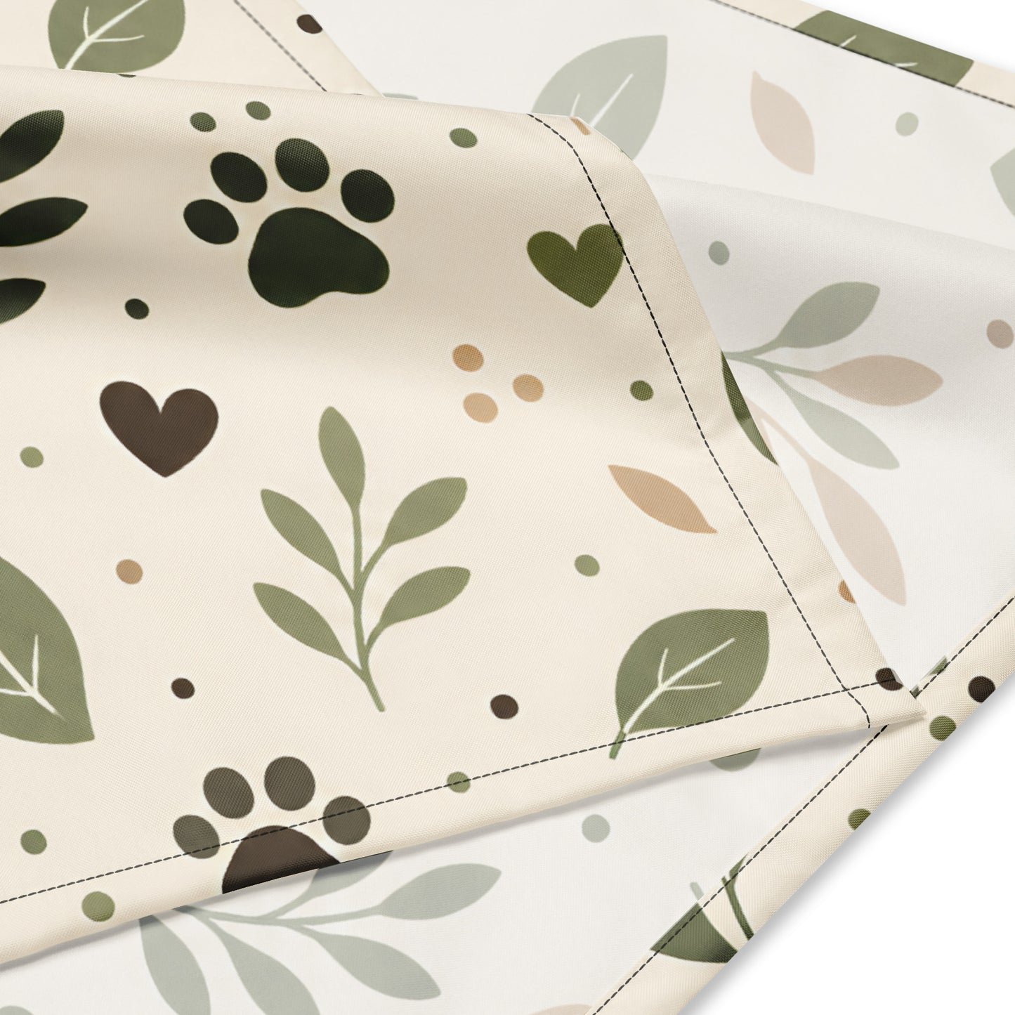 Close-up of the Sage Paw Everyday Pet Bandana fabric with paw, heart, leaf details, and double-folded edges