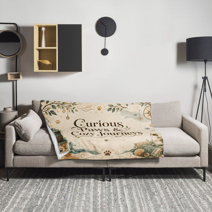 Curious Paws & Cozy Journeys throw blanket styled on a sofa in a living room