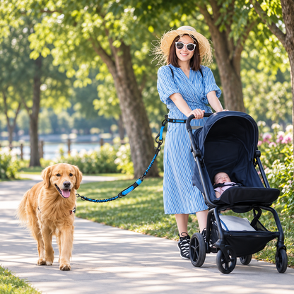 Woman pushing a stroller while walking a dog with a blue hands-free waist leash in a park