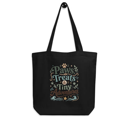 Angled view of the black Paws, Treats & Tiny Adventures organic cotton tote bag.