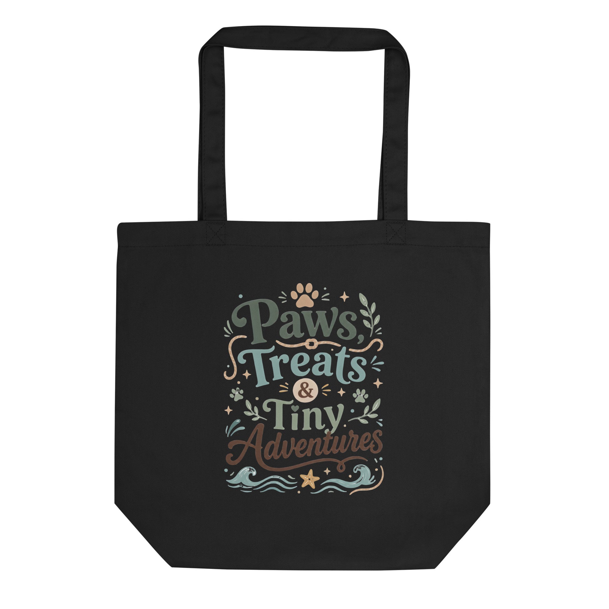Black organic cotton tote bag with Paws, Treats & Tiny Adventures pet parent artwork.