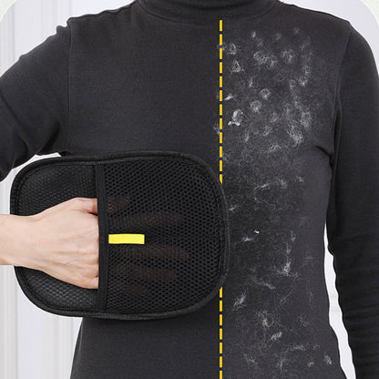 Hand using a black pet grooming mitt to collect loose pet hair from fabric.